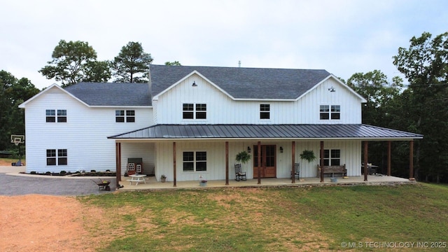 11457 N 510th Rd, Tahlequah, OK 74464 - modern farmhouse with a front yard, board and batten siding, and covered porch
