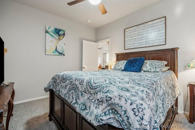 carpeted bedroom with ceiling fan and baseboards