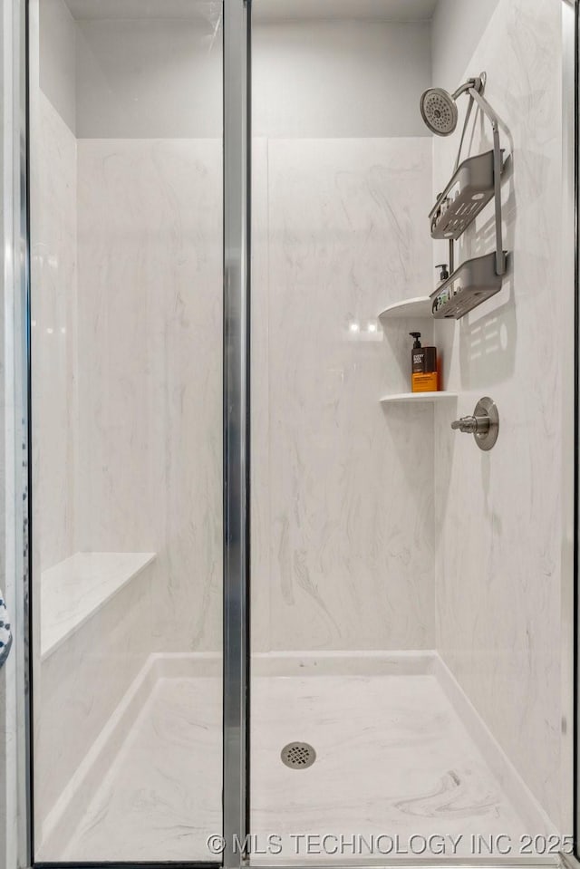 full bathroom with a marble finish shower