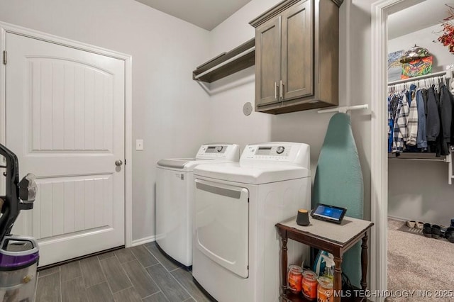 laundry room featuring cabinet space, independent washer and dryer, baseboards, and dark wood-style flooring