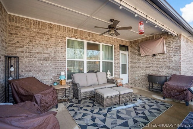view of patio with an outdoor living space and ceiling fan
