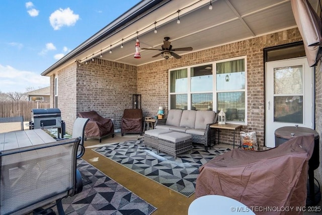 view of patio / terrace featuring a grill, fence, ceiling fan, and an outdoor living space