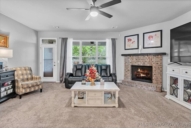 living area with a ceiling fan, visible vents, carpet, and a fireplace