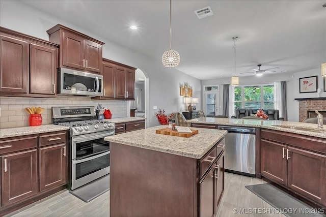 kitchen featuring appliances with stainless steel finishes, a sink, visible vents, and light wood-type flooring