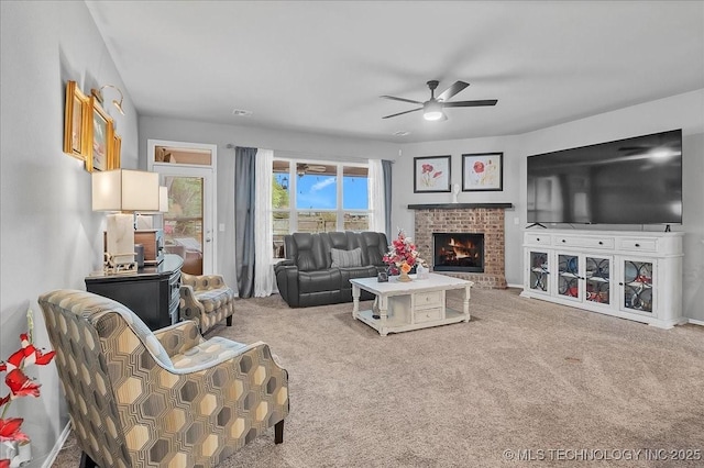 carpeted living area featuring a fireplace and ceiling fan