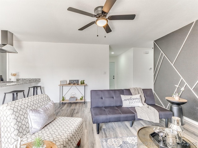 living room featuring ceiling fan and wood finished floors