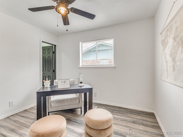 office space featuring baseboards, wood finished floors, and a ceiling fan