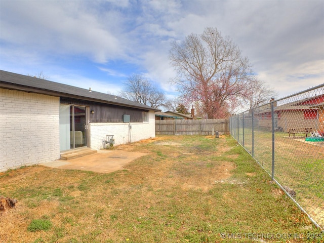 view of yard with a patio and a fenced backyard