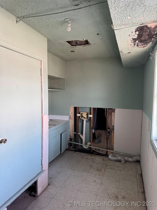 bathroom featuring tile patterned floors and washer / dryer