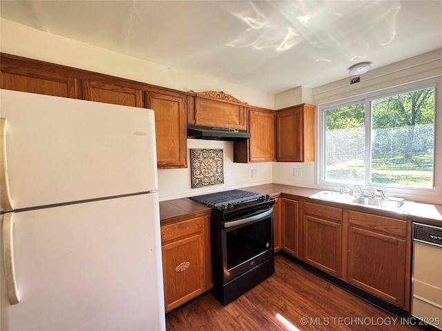 111 N Logan Dr, Tahlequah, OK 74464 - kitchen with freestanding refrigerator, gas range, under cabinet range hood, a sink, and dishwasher