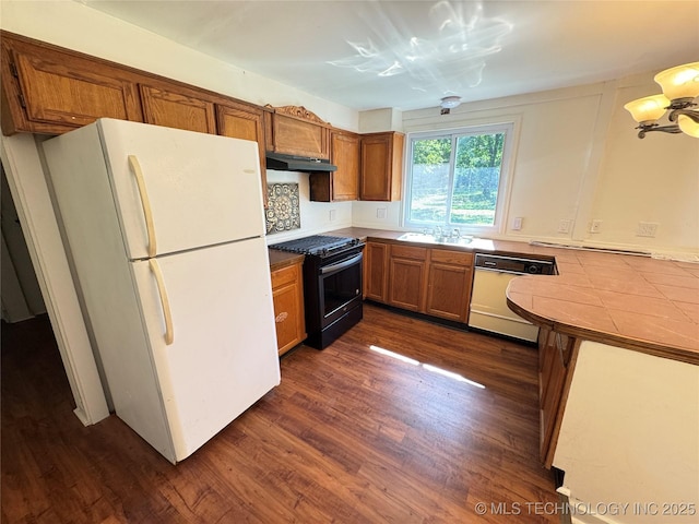 111 N Logan Dr, Tahlequah, OK 74464 - kitchen with white appliances, under cabinet range hood, brown cabinets, dark wood-style floors, and tile counters