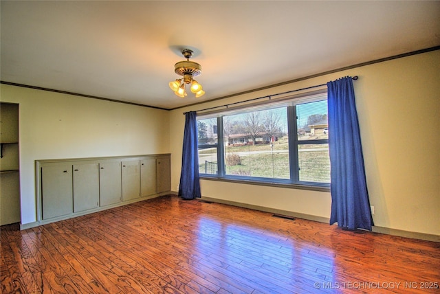 6508 W Cameron St, Sand Springs, OK 74127 - unfurnished room with wood finished floors, baseboards, and ornamental molding
