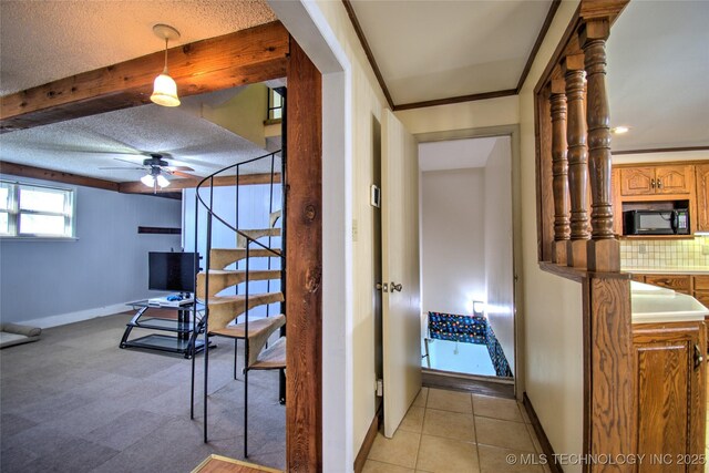 6508 W Cameron St, Sand Springs, OK 74127 - corridor featuring crown molding, baseboards, stairway, light tile patterned flooring, and a textured ceiling