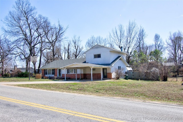6508 W Cameron St, Sand Springs, OK 74127 - view of front of house with a front lawn, fence, concrete driveway, an attached carport, and brick siding