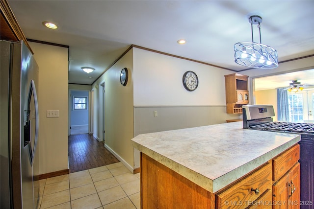 6508 W Cameron St, Sand Springs, OK 74127 - kitchen with light tile patterned flooring, stainless steel appliances, light countertops, crown molding, and brown cabinets