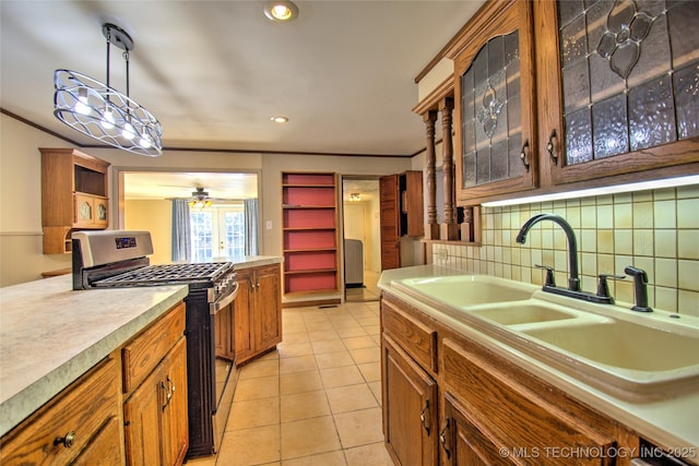 6508 W Cameron St, Sand Springs, OK 74127 - kitchen with stainless steel gas stove, a sink, open shelves, brown cabinetry, and light tile patterned floors