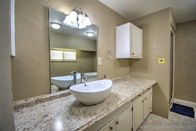 6508 W Cameron St, Sand Springs, OK 74127 - bathroom with vanity, a notable chandelier, and a textured wall