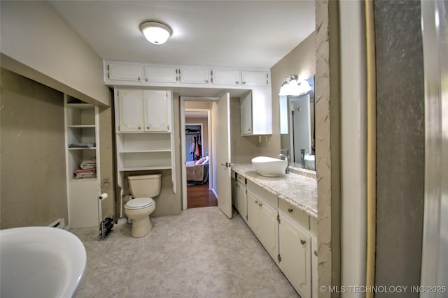 6508 W Cameron St, Sand Springs, OK 74127 - full bath with toilet, vanity, and a baseboard radiator