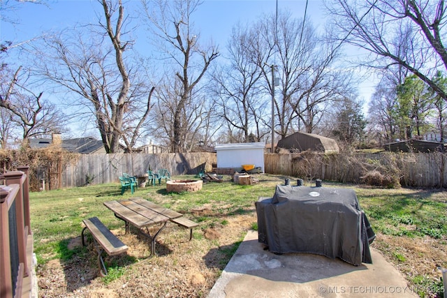 6508 W Cameron St, Sand Springs, OK 74127 - view of yard with an outbuilding, an outdoor fire pit, a storage shed, and a fenced backyard