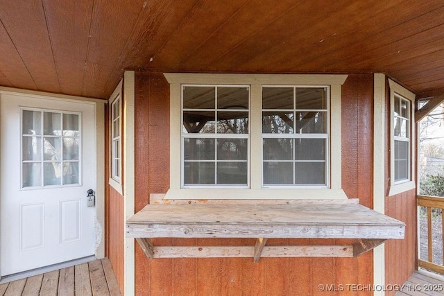 view of exterior entry with a porch