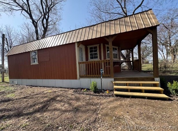 view of front of property with a porch and metal roof