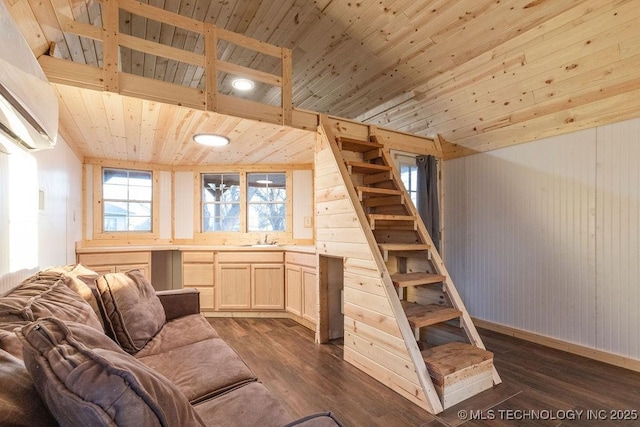 living area featuring stairway, wood walls, wood ceiling, and dark wood-style flooring