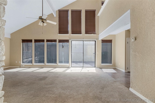 6505 S Oswego Ave, Tulsa, OK 74136 - unfurnished living room featuring high vaulted ceiling, carpet, baseboards, and ceiling fan
