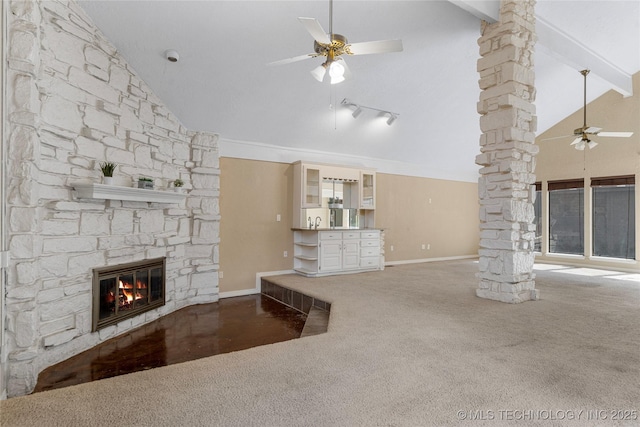 6505 S Oswego Ave, Tulsa, OK 74136 - unfurnished living room featuring ornate columns, carpet flooring, a fireplace, and a ceiling fan