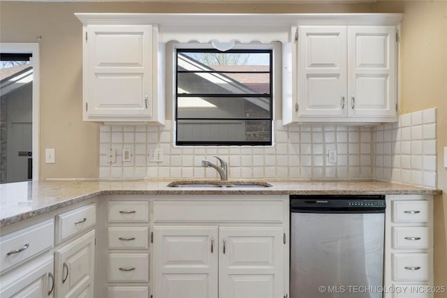6505 S Oswego Ave, Tulsa, OK 74136 - kitchen featuring tasteful backsplash, a sink, dishwasher, white cabinets, and light stone countertops