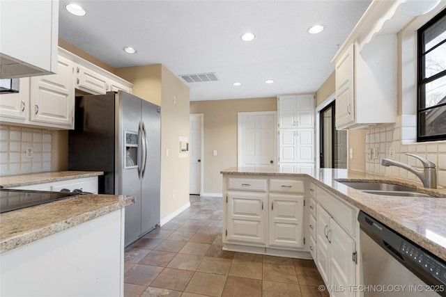 6505 S Oswego Ave, Tulsa, OK 74136 - kitchen featuring visible vents, light stone countertops, appliances with stainless steel finishes, white cabinetry, and a sink