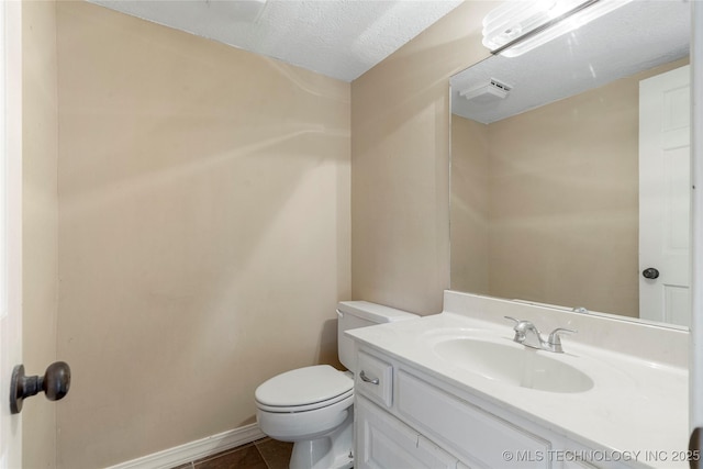 6505 S Oswego Ave, Tulsa, OK 74136 - bathroom featuring vanity, toilet, baseboards, a textured ceiling, and tile patterned floors