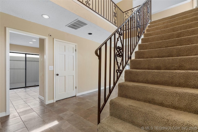 6505 S Oswego Ave, Tulsa, OK 74136 - stairway with baseboards, visible vents, and recessed lighting