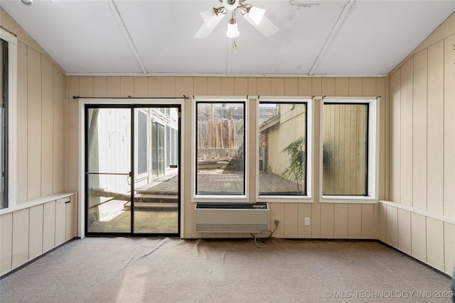 6505 S Oswego Ave, Tulsa, OK 74136 - unfurnished room featuring carpet floors, a wall unit AC, ceiling fan, and a wealth of natural light