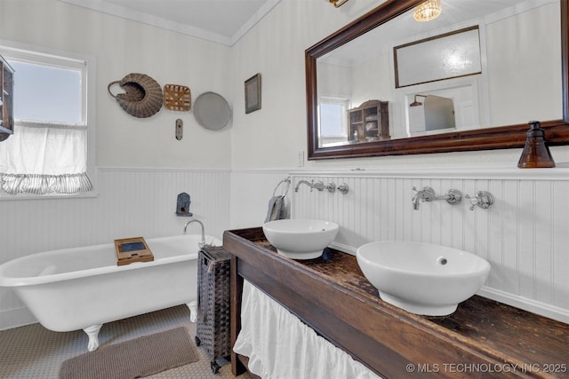 5174 Silo Rd, Durant, OK 74701 - full bath with crown molding, a freestanding tub, wainscoting, and a sink
