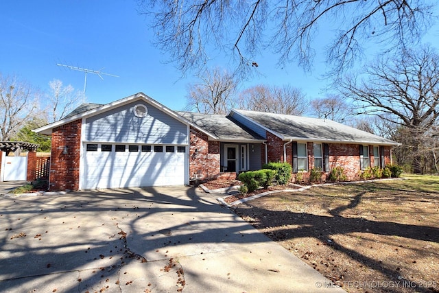 1430 Williams St, Fort Gibson, OK 74434 - ranch-style home with brick siding, driveway, an attached garage, and a gate