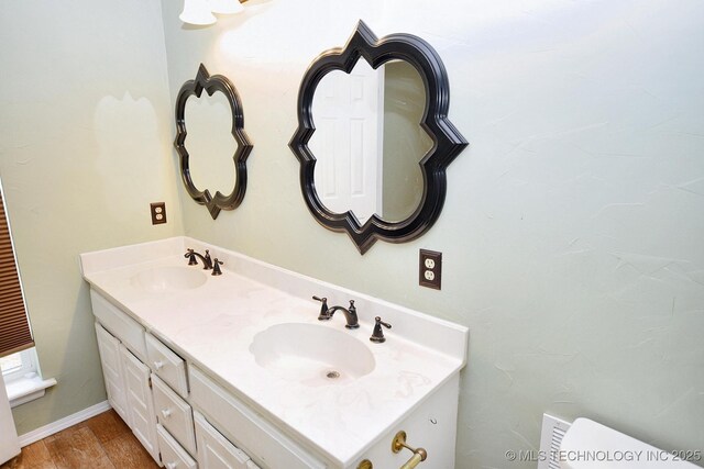 1430 Williams St, Fort Gibson, OK 74434 - bathroom with double vanity, toilet, wood finished floors, and a sink
