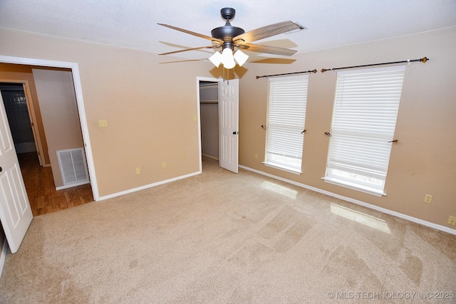 1430 Williams St, Fort Gibson, OK 74434 - unfurnished bedroom featuring visible vents, a walk in closet, ceiling fan, baseboards, and carpet