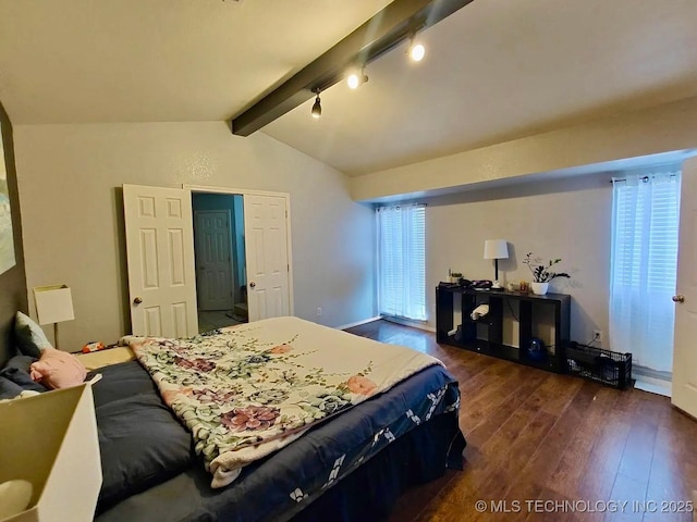 bedroom featuring rail lighting, vaulted ceiling with beams, and dark wood-type flooring