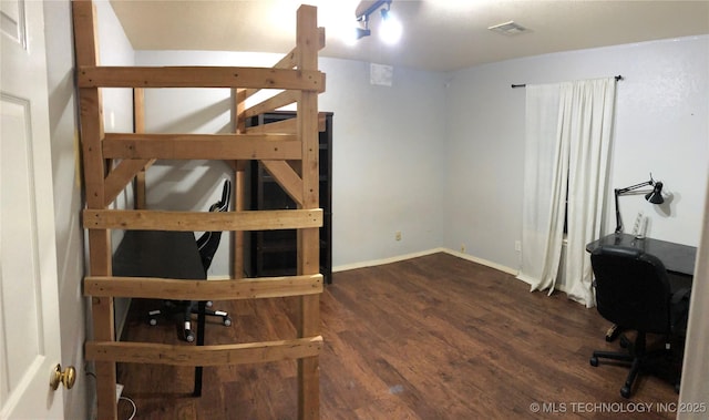 office area featuring wood finished floors, visible vents, and baseboards