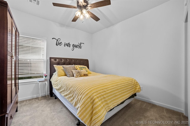 bedroom with baseboards, visible vents, and carpet