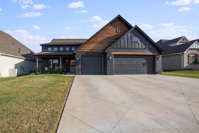 view of front of property featuring board and batten siding, brick siding, a garage, driveway, and a front yard