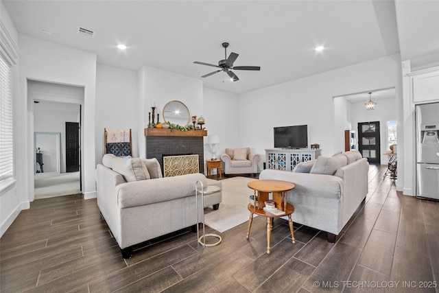 living area featuring recessed lighting, dark wood-style flooring, a fireplace, ceiling fan, and visible vents