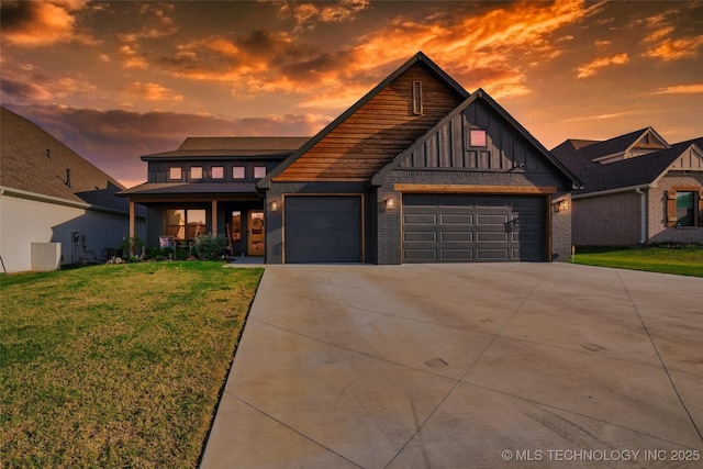 view of front of house featuring driveway, board and batten siding, a lawn, and an attached garage