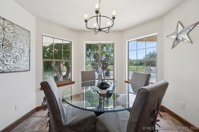 11712 E 121st St, Collinsville, OK 74021 - dining area with a chandelier, plenty of natural light, and baseboards