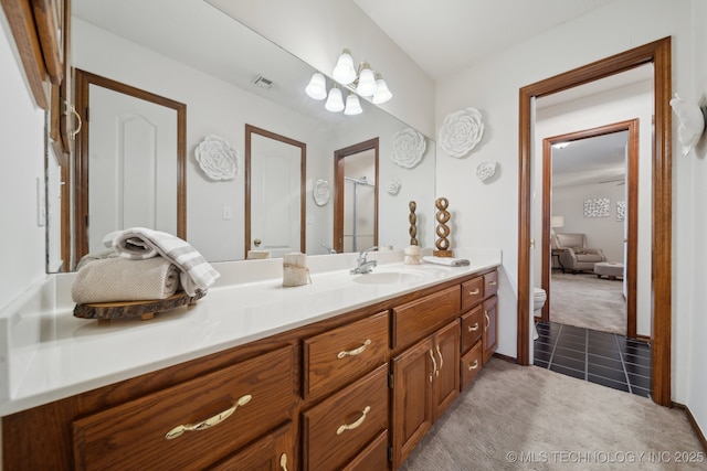 11712 E 121st St, Collinsville, OK 74021 - full bathroom with vanity, a shower with door, tile patterned flooring, and toilet