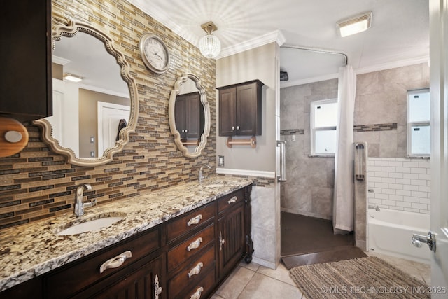 bathroom featuring tile patterned flooring, ornamental molding, tasteful backsplash, and a sink