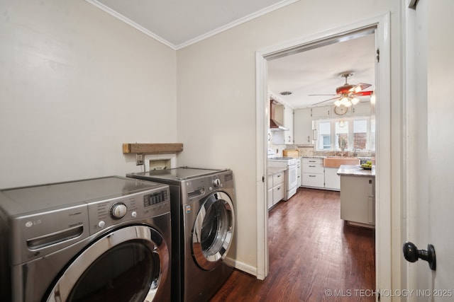 clothes washing area featuring ornamental molding, a ceiling fan, dark wood finished floors, washing machine and dryer, and laundry area