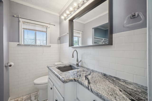 bathroom featuring a healthy amount of sunlight, tile walls, toilet, and ornamental molding