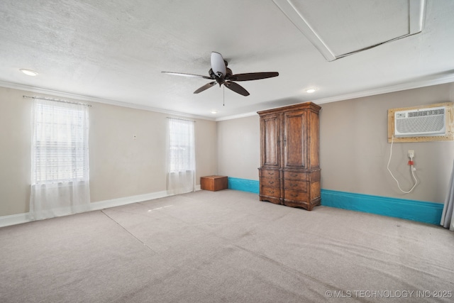 unfurnished room with a wall mounted AC, crown molding, baseboards, light colored carpet, and ceiling fan