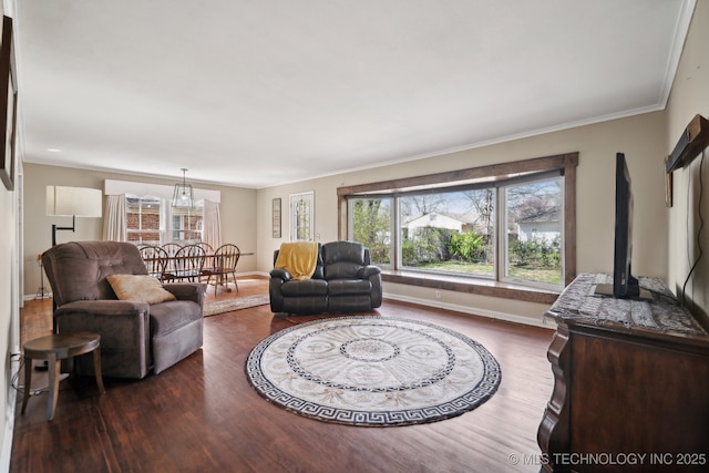living area featuring wood finished floors, baseboards, and ornamental molding